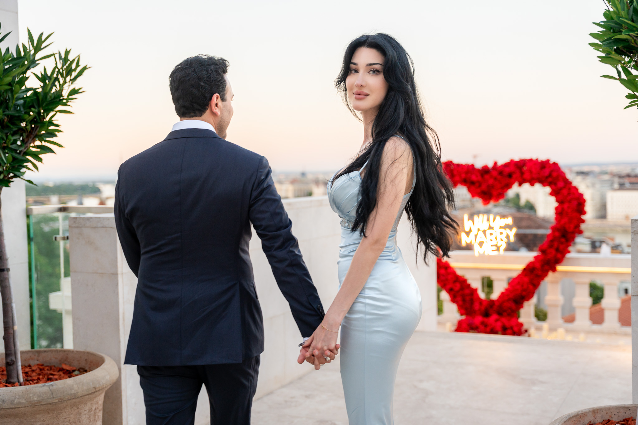 Luxury private proposal on a romantic terrace with red rose heart and Budapest skyline {{brizy_dc_image_alt imageSrc=