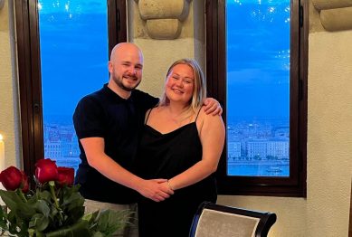 Couple smiling at the table in front of the terrace of Fisherman's Bastion after their engagement