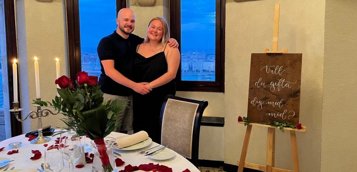 Couple smiling at the table in front of the terrace of Fisherman's Bastion after their engagement